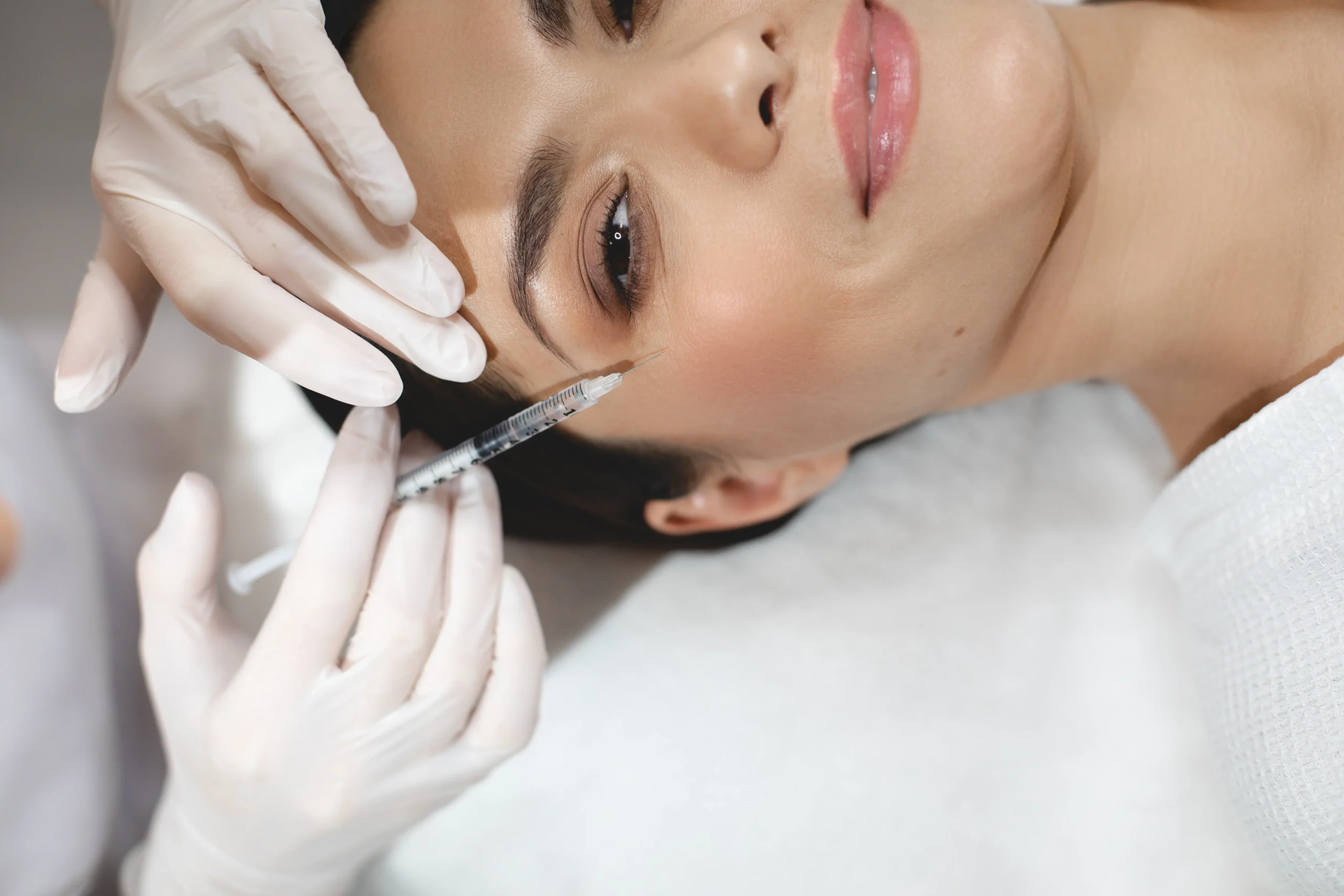 Provider assessing a patient's full face for a facial balancing plan in Oakville