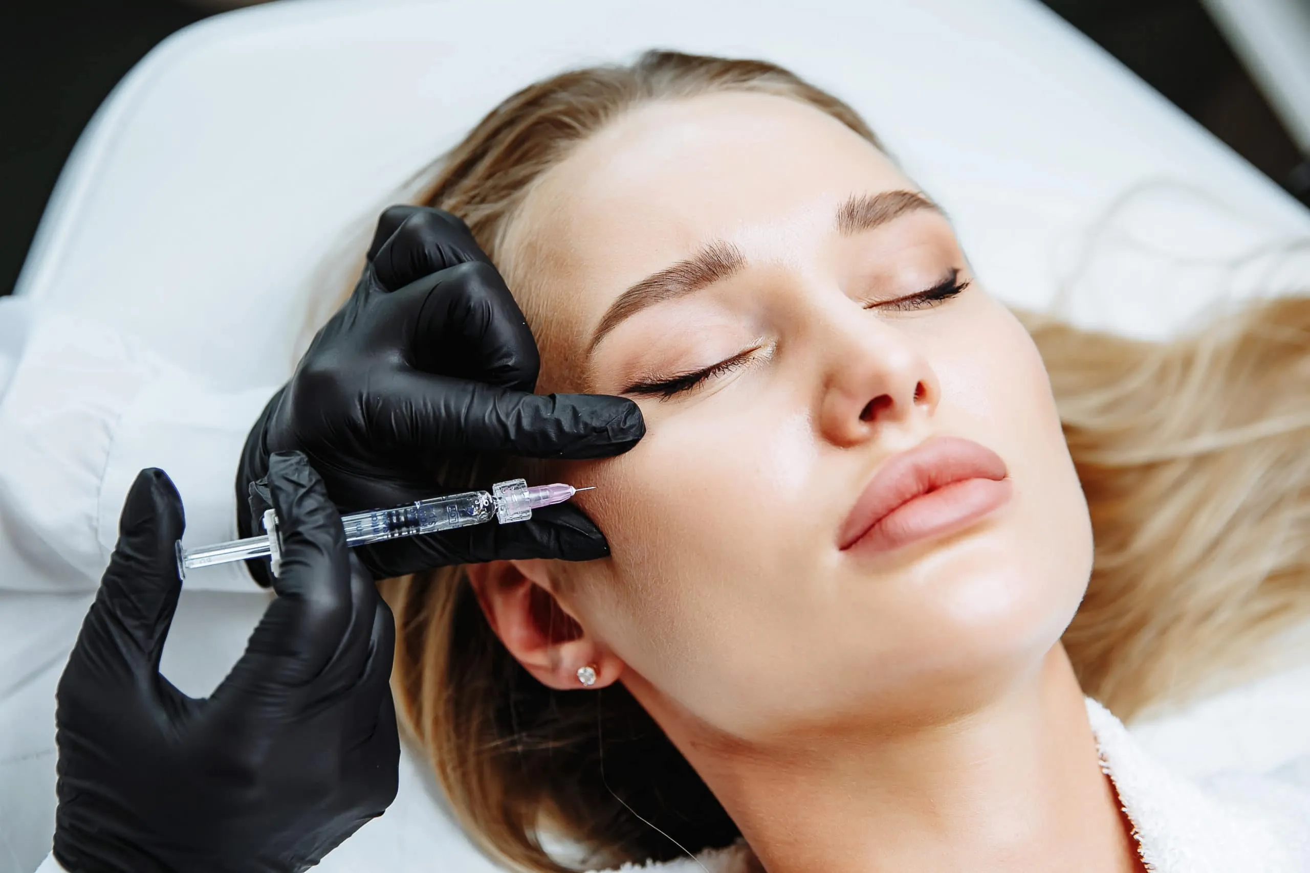 Advanced aesthetic nurse injector performing cheek filler at Oakville Flawless Cosmetic