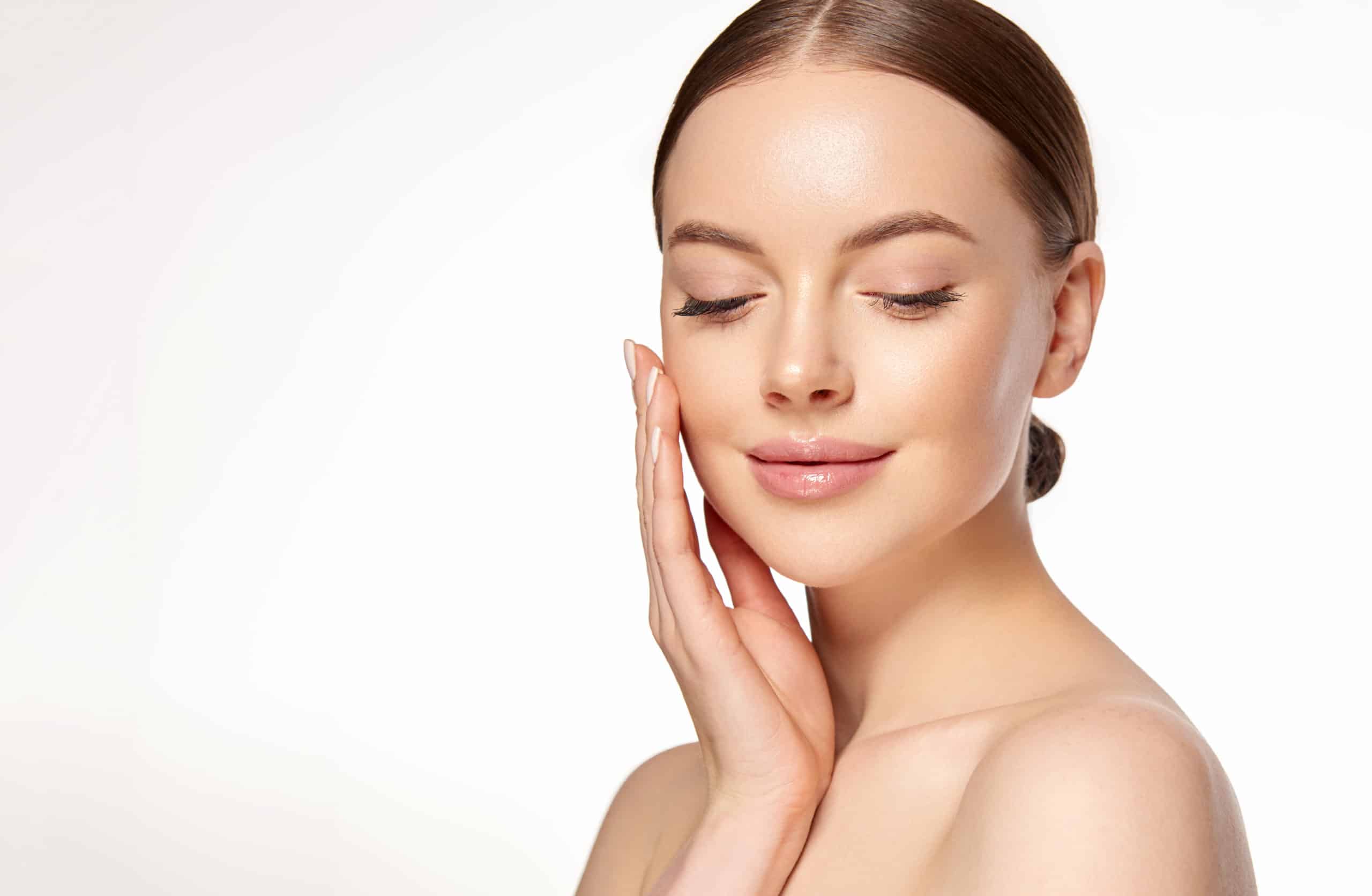 Aesthetic nurse assessing a patient's face before dermal filler treatment in Oakville