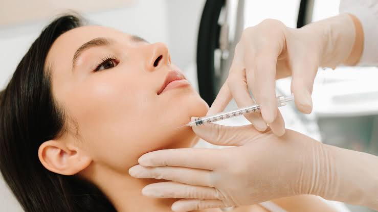 Advanced aesthetic nurse injector performing jawline filler at Oakville Flawless Cosmetic