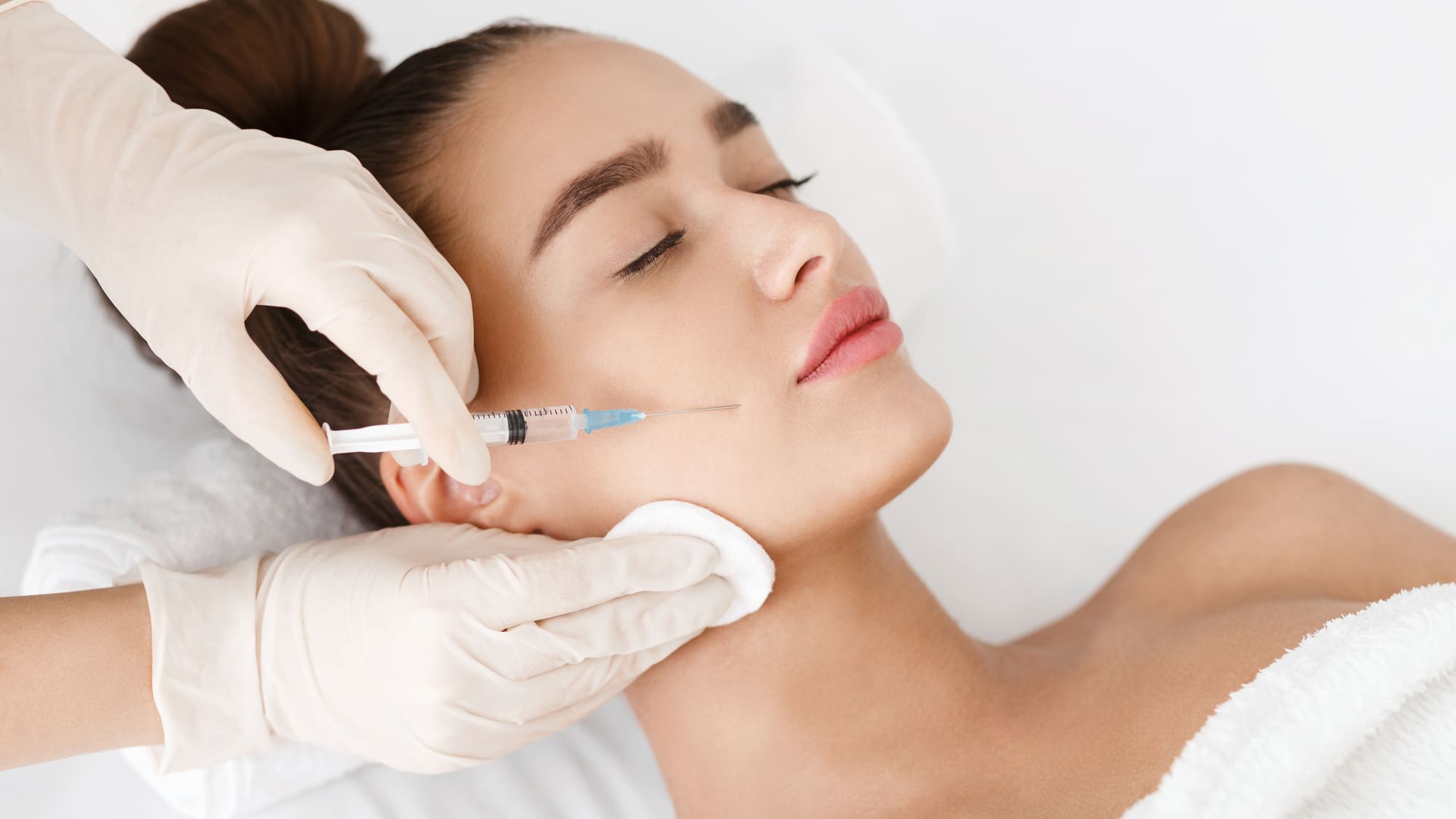 Woman receiving filler to soften marionette lines at the mouth corners in Oakville