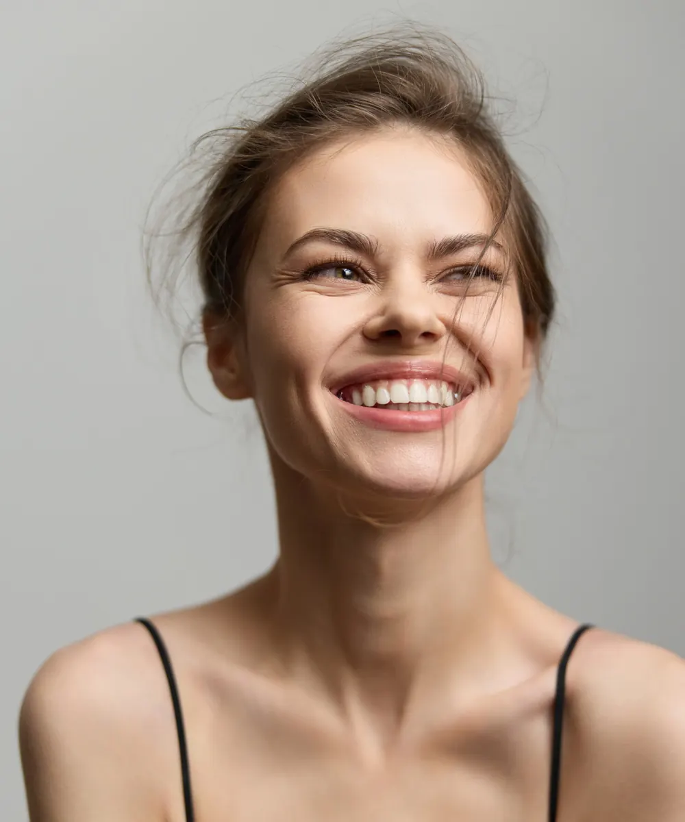Woman smiling naturally with a smooth eye area