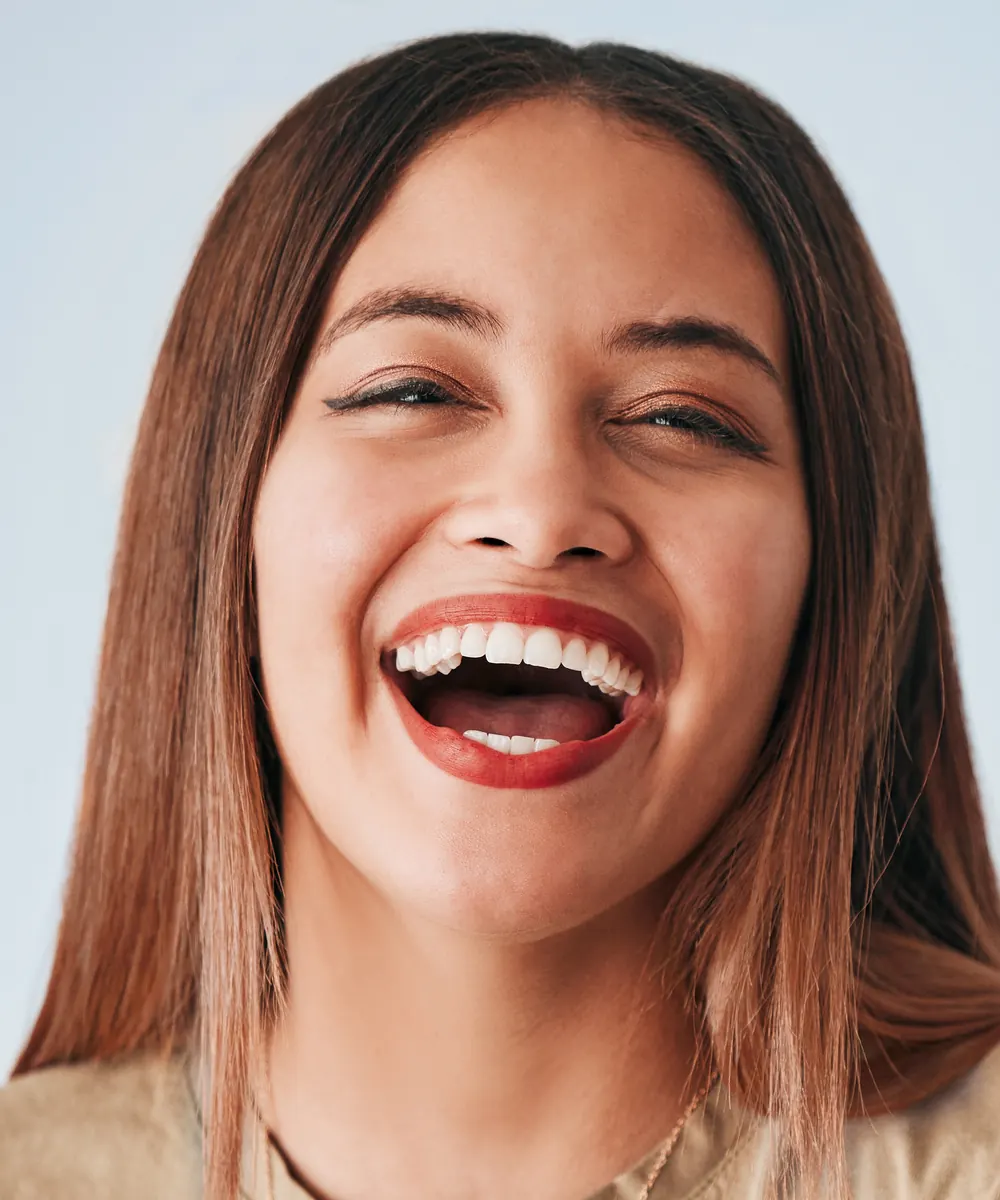 Woman laughing with a high lip line that shows more of the upper gum