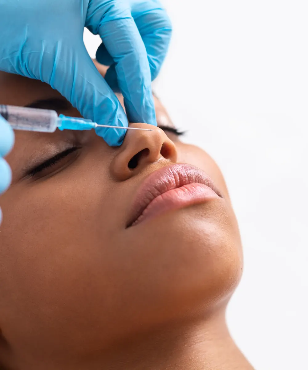 Cosmetic filler being injected into the bridge of the nose during non surgical rhinoplasty