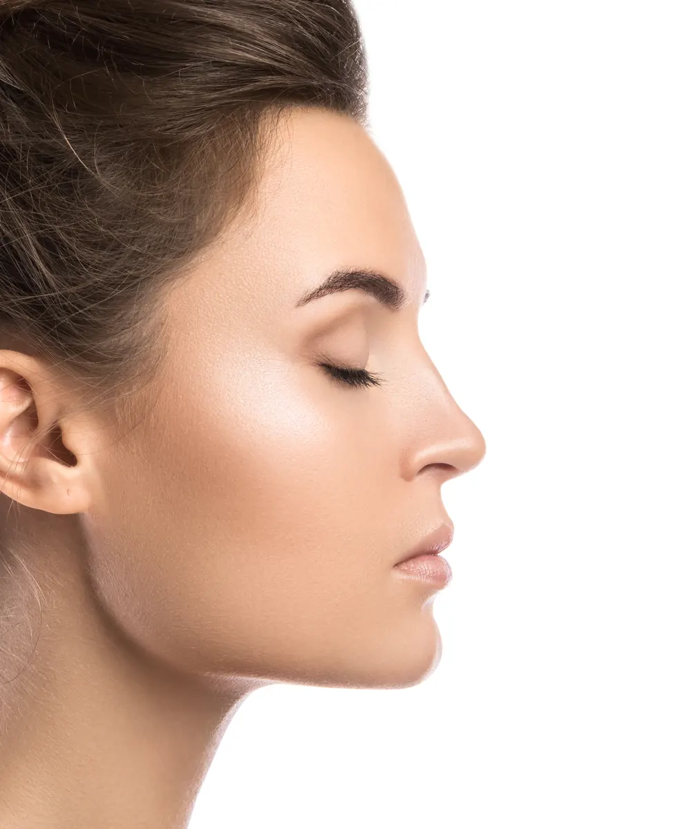Profile portrait of a woman with hair pulled back showing a smooth nasal line