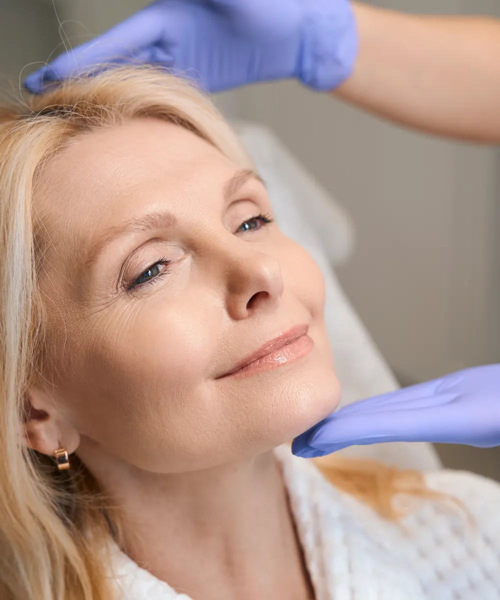Injectable treatment being carried out on a patient's cheek in a clinical setting