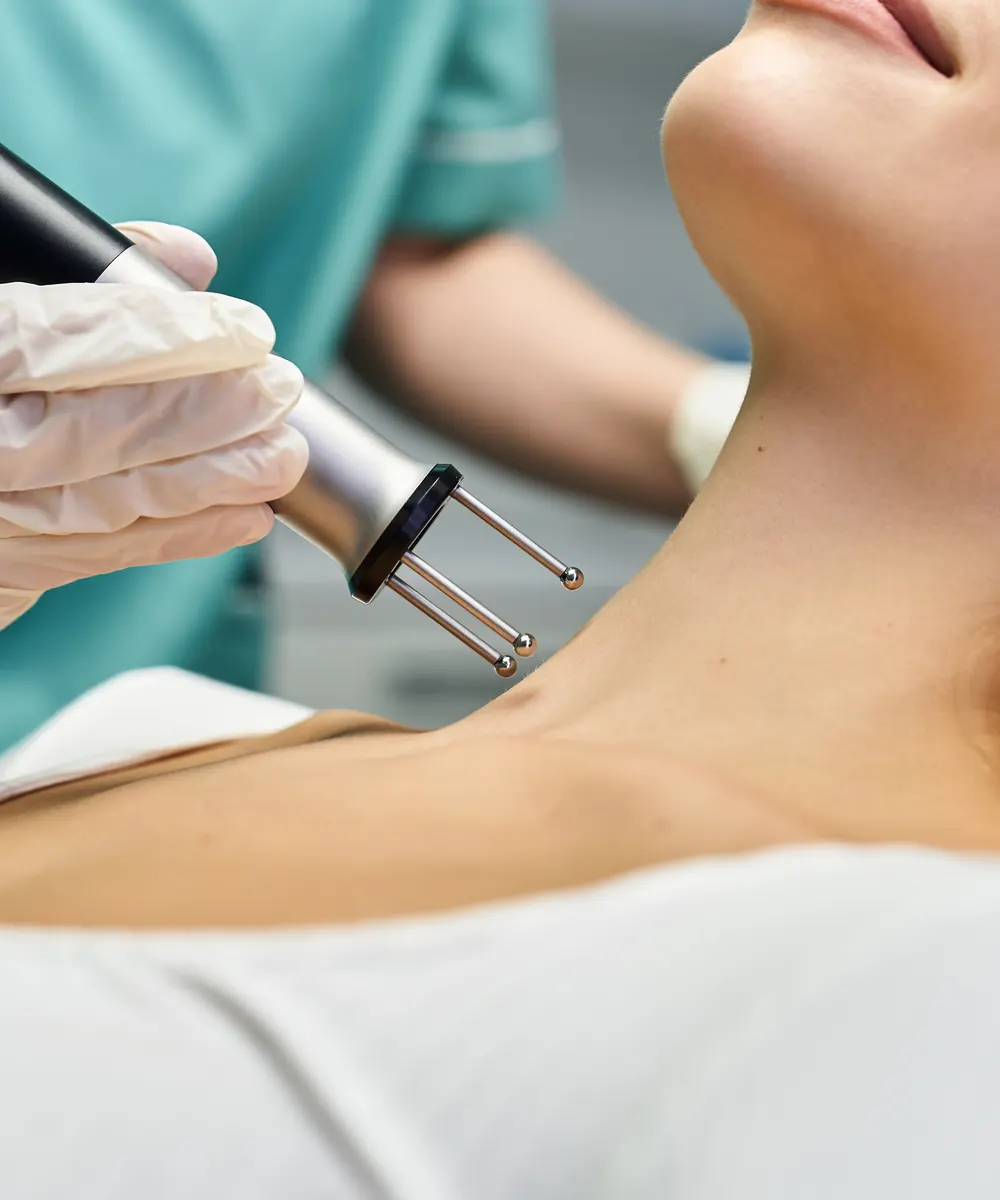 Clinician applying a non surgical skin tightening device to a patient's neck