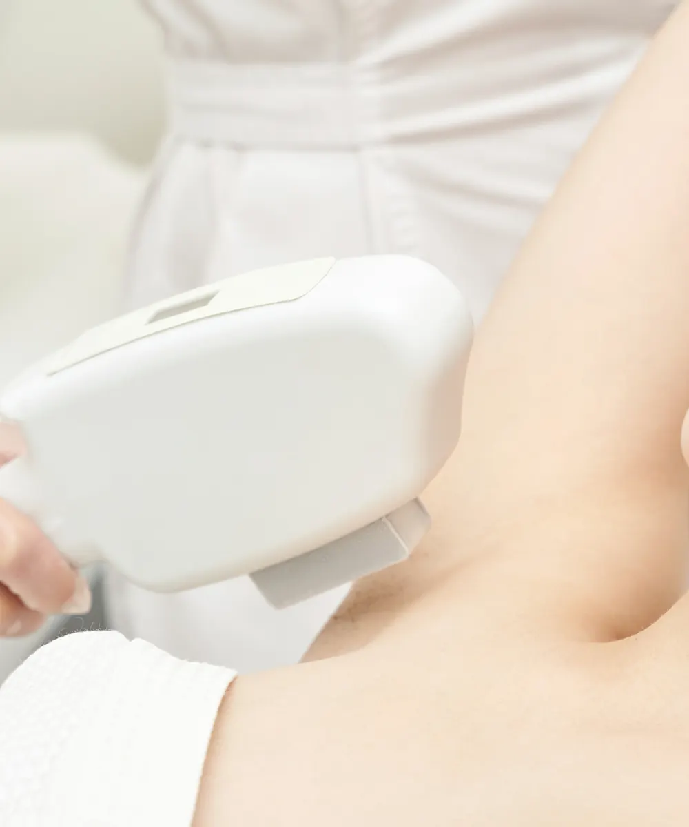 Young woman receiving a laser hair removal treatment in a clinic