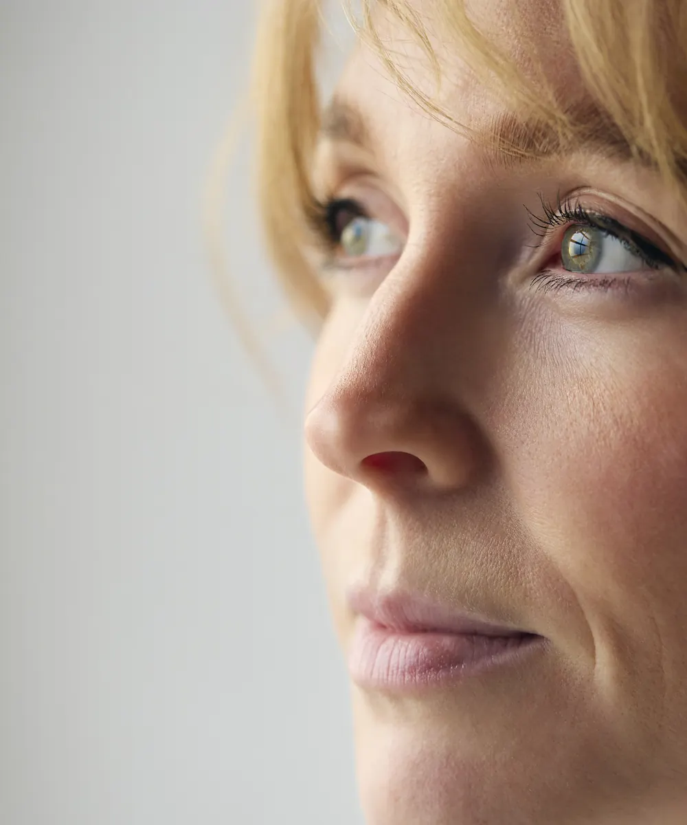 Close view of fine lines and skin texture around a woman's eye and cheek